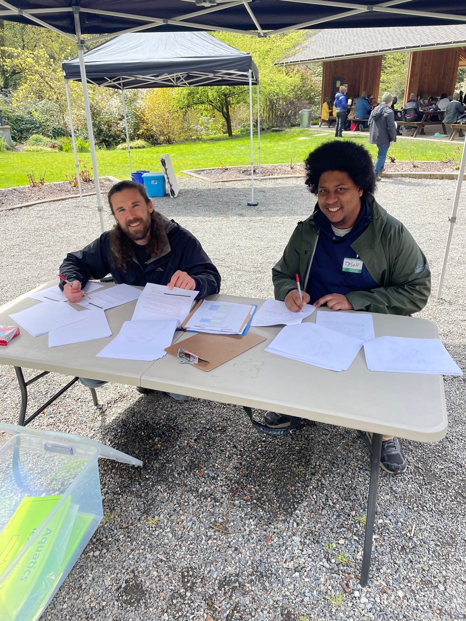 Connor and Tyson from PCD proctor the aquatic ecology station. Many papers on table in front of them