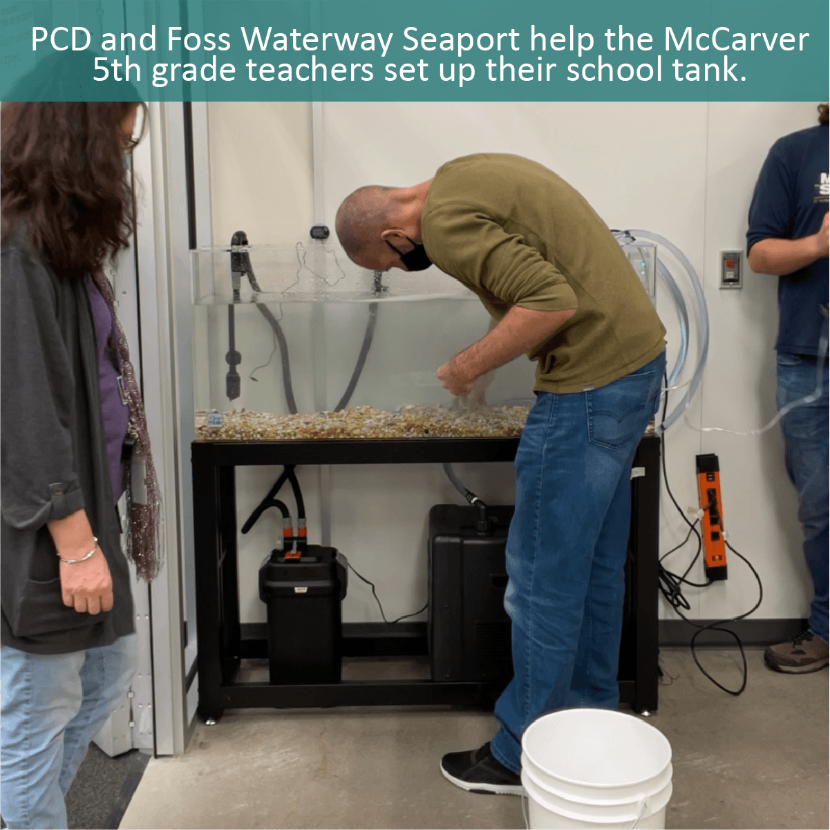 PCD and Foss Waterway Seaport help the McCarver 5th grade teachers set up their school tank.