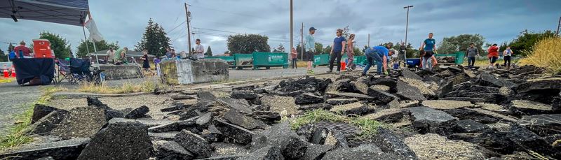 Pavement at Peck Parking Lot broken up before volunteers remove it. 