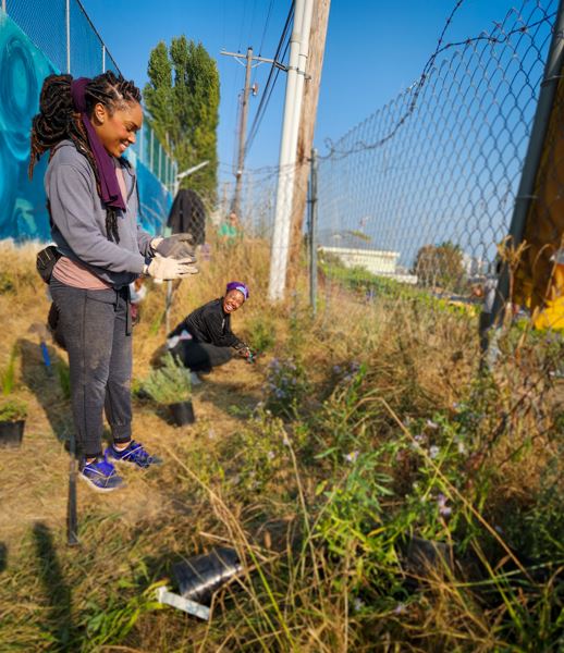Lisa and Raeshawna take a look at their hard work. Volunteers put more than 300 plants in the soil!