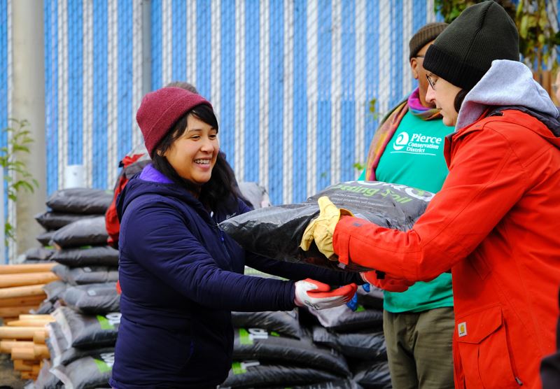 VCC Program Coordinator Kim Pham passes Tagro to a volunteer. 