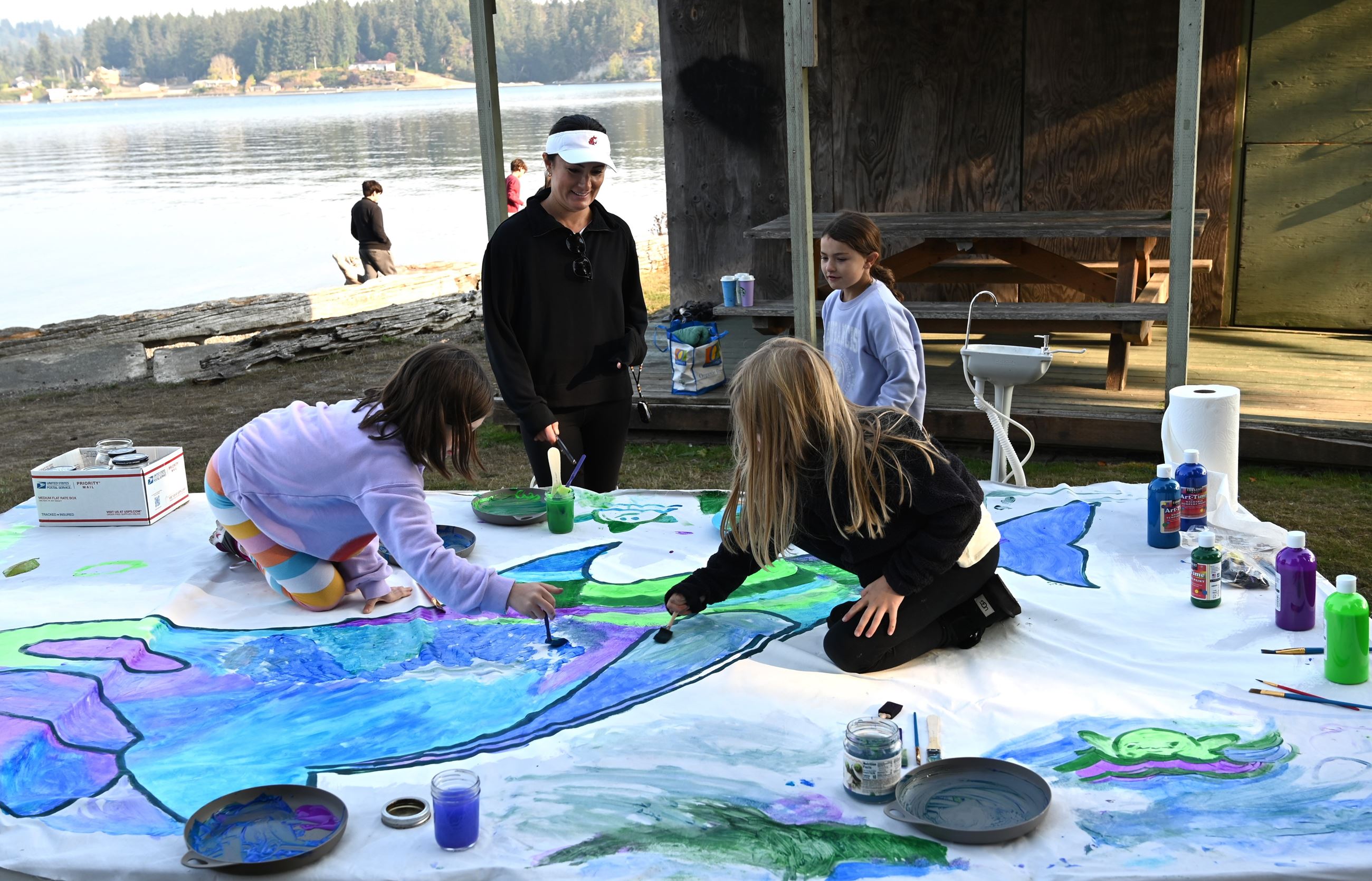 Painting the entire 6x10 foot banner took teamwork, with some kids climbing up on the table to paint