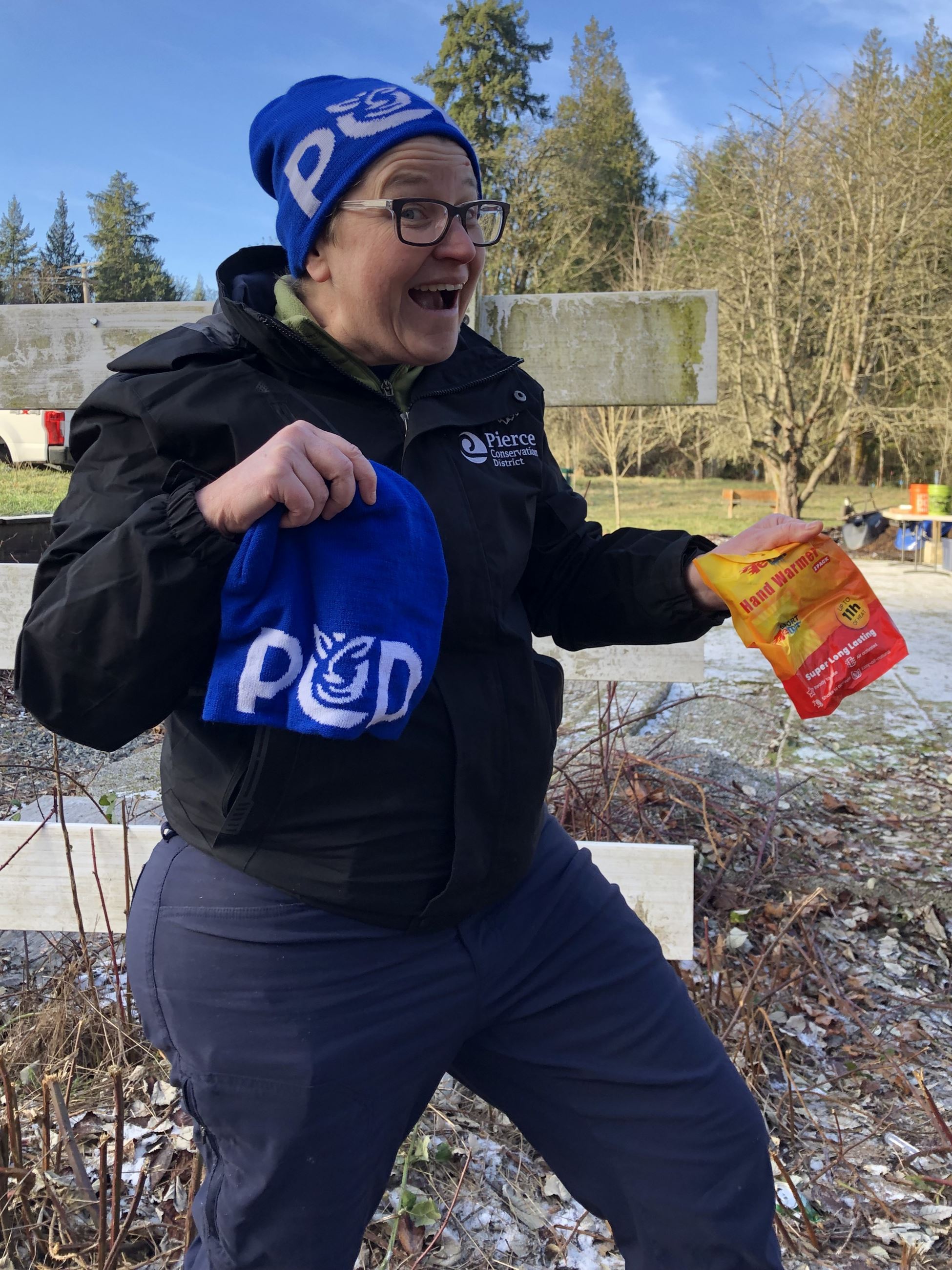 Dana sports a jacket and PCD Beanie while handing out beanies and handwarmers