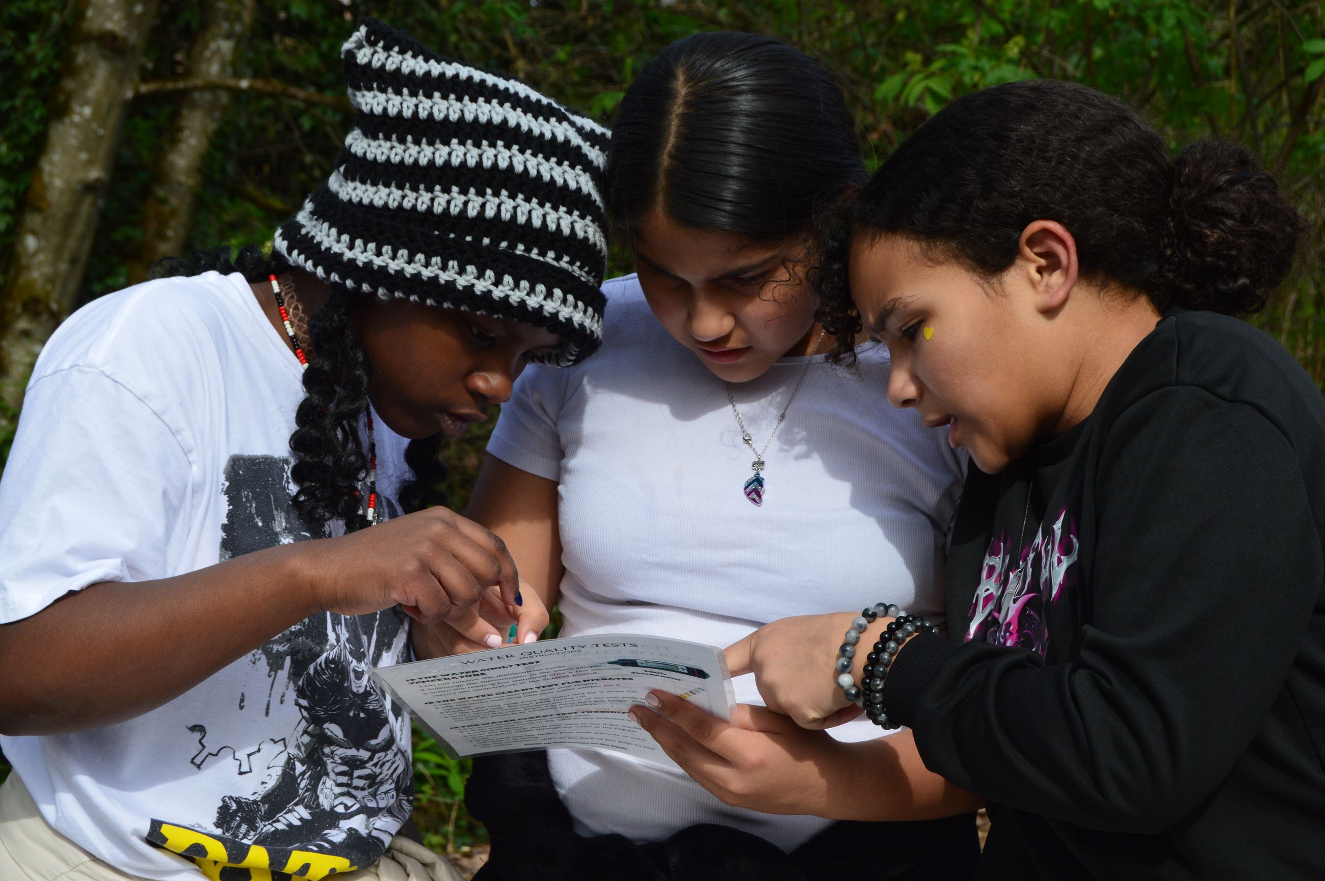 Three students comparing notes.