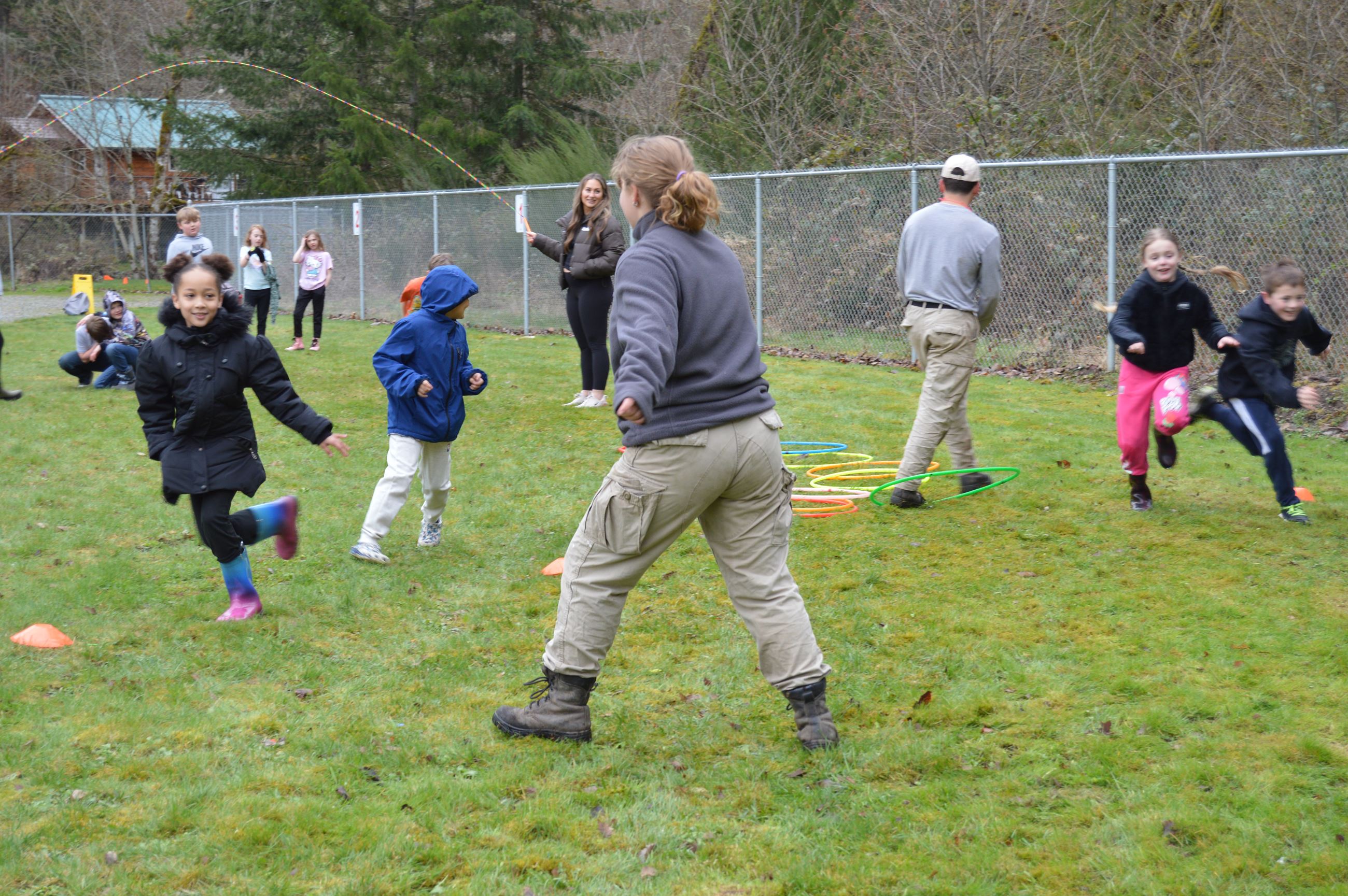 Kids running and jumping through obstacle course that mirrors salmon migration
