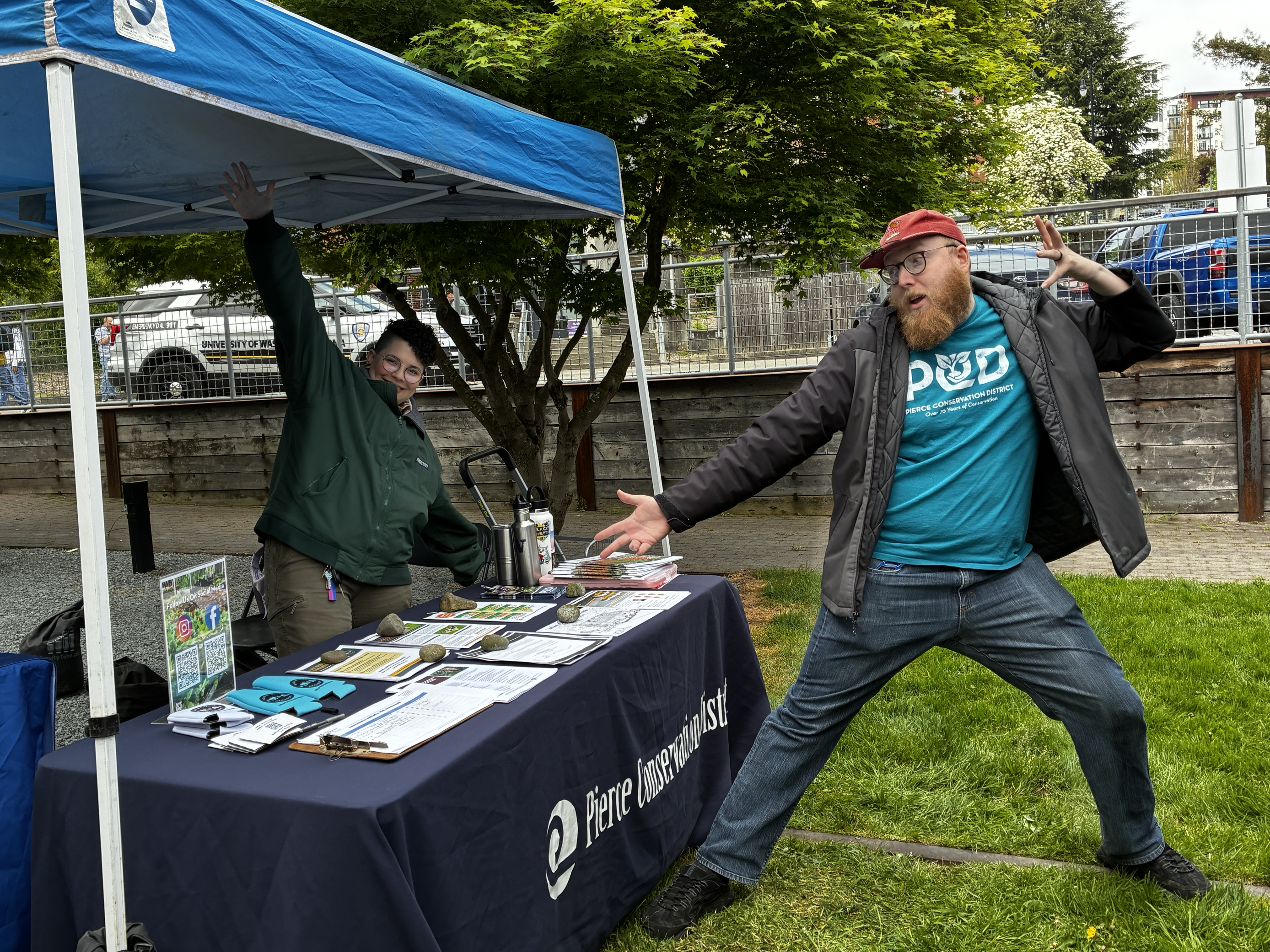 PCD staff and volunteer showing off their 2025 Sustainability Expo booth.