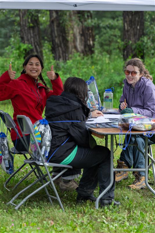 Group of high school students taking a written test under a canopy